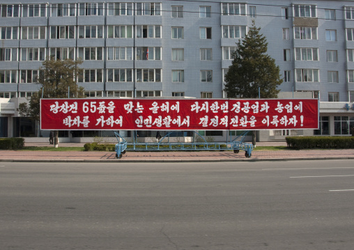 Propaganda slogan about industry and agriculture on a red billboard in town, Pyongan Province, Pyongyang, North Korea
