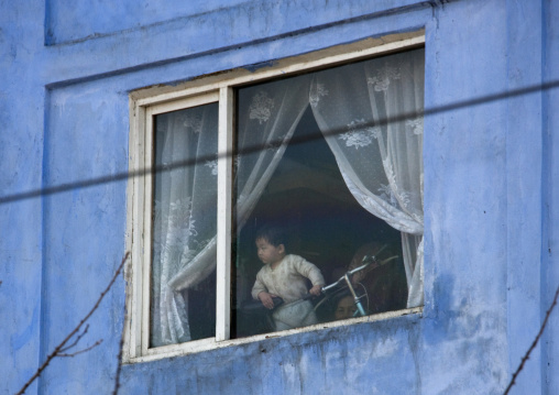 North Korean child looking thru a window, Pyongan Province, Pyongyang, North Korea