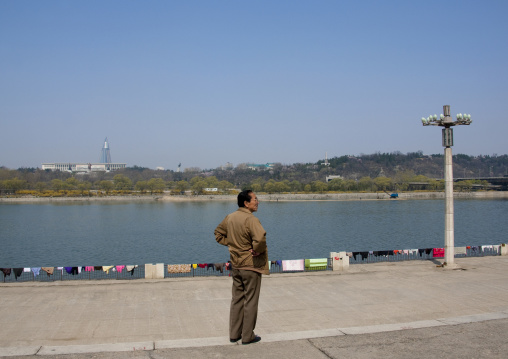 North Korean man in front of linen drying on the banks of Taedong river, Pyongan Province, Pyongyang, North Korea