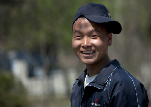 Smiling North Korean boy with a cap, Pyongan Province, Pyongyang, North Korea