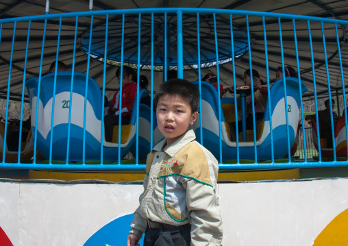 North Korean boy in front of an attraction in Taesongsan funfair, Pyongan Province, Pyongyang, North Korea