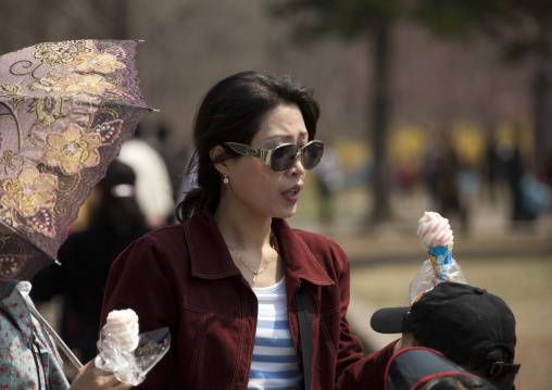 North Korean rich woman with dior sunglasses in Taesongsan funfair, Pyongan Province, Pyongyang, North Korea
