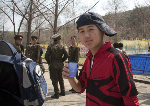 North Korean teenager with a cap at Taesongsan funfair, Pyongan Province, Pyongyang, North Korea
