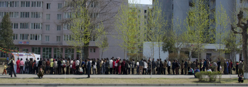 North Korean people queueing in the street to buy food, Pyongan Province, Pyongyang, North Korea