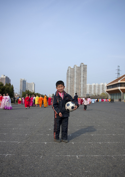 North Korean boy with a ball in the street, Pyongan Province, Pyongyang, North Korea