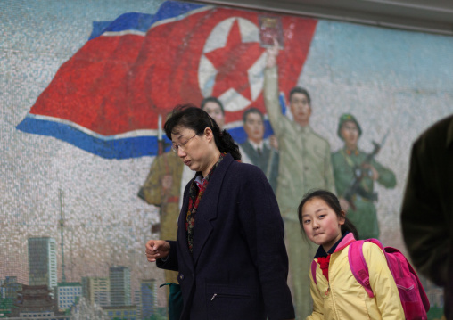 North Korean people in the subway in front of a propaganda mosaic, Pyongan Province, Pyongyang, North Korea