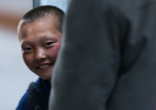 Shy North Korean boy smiling, Pyongan Province, Pyongyang, North Korea