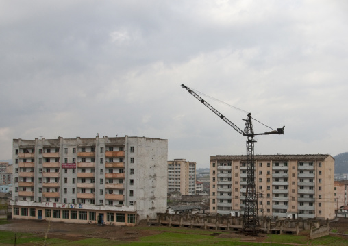 Crane in the middle of decrepit buildings, North Hwanghae Province, Kaesong, North Korea