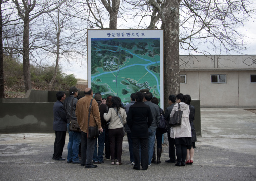 Tourists in front of a map of the Demilitarized Zone, North Hwanghae Province, Panmunjom, North Korea