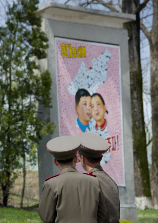 North Korean soldiers in the Demilitarized Zone in front of a propaganda billboard for the reunification, North Hwanghae Province, Panmunjom, North Korea