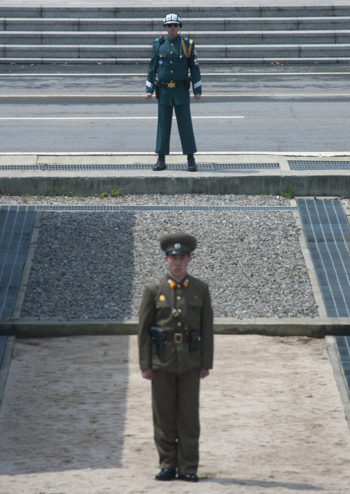 North Korean soldiers standing in front of the United Nations conference rooms on the demarcation line in the Demilitarized Zone, North Hwanghae Province, Panmunjon, North Korea
