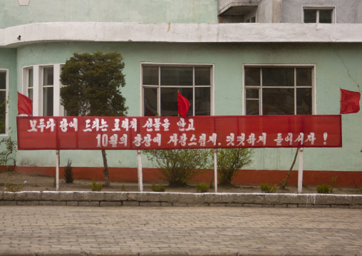 Propaganda slogan on a red billboard in town, North Hwanghae Province, Kaesong, North Korea