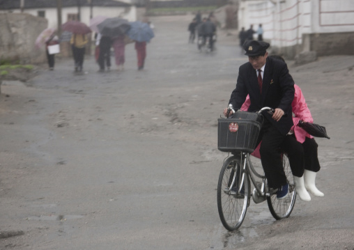 North Korean student giving a lift to a woman on his bicycle, North Hwanghae Province, Kaesong, North Korea