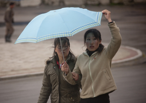 North Korean women under an umbrella, North Hwanghae Province, Kaesong, North Korea