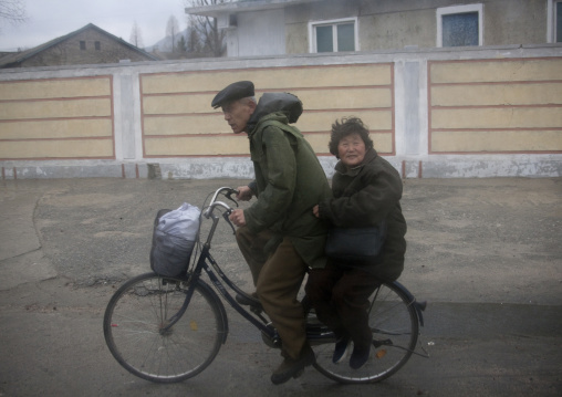 North Korean old coule on a bicycle, North Hwanghae Province, Kaesong, North Korea