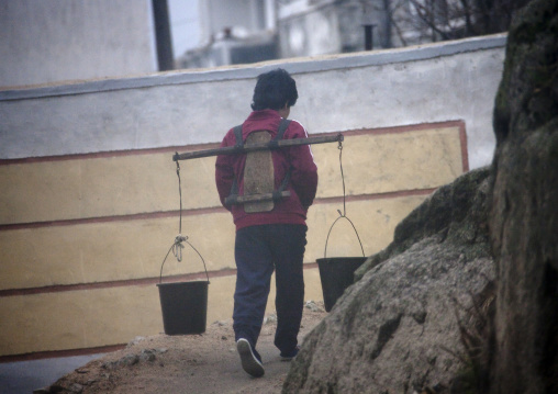 North Korean woman carrying buckets full of water, North Hwanghae Province, Kaesong, North Korea