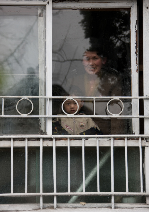 North Korean woman and child at window, North Hwanghae Province, Kaesong, North Korea
