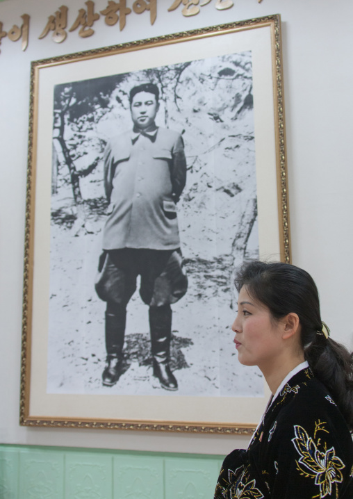 North Korean woman in Jonsung revolutionary museum in front of Kim Il-sung portrait, Pyongan Province, Pyongyang, North Korea