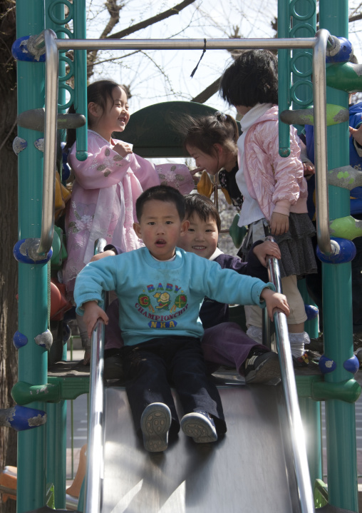 North Korean children having fun in playground in Kwangbok school, Pyongan Province, Pyongyang, North Korea