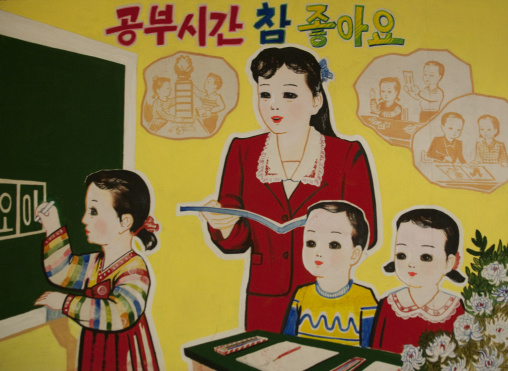 Propaganda poster in a school depicting a teatcher with pupils, Pyongan Province, Pyongyang, North Korea