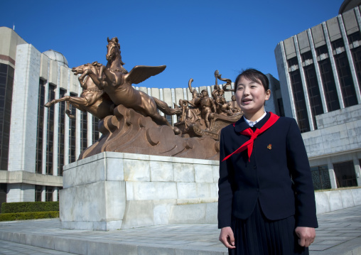 North Korean pioneer in front of Mangyongdae children s palace statue, Pyongan Province, Pyongyang, North Korea