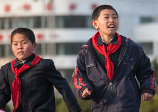 North Korean pioneer boys running in the street, Pyongan Province, Pyongyang, North Korea