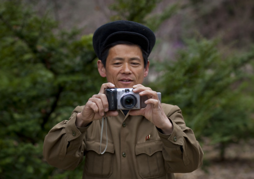 North Korean man taking pictures with a canon digital camera, Hyangsan county, Mount Myohyang, North Korea