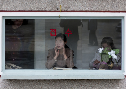 North Korean women behind a ticket window in Pohyon temple, Hyangsan county, Mount Myohyang, North Korea