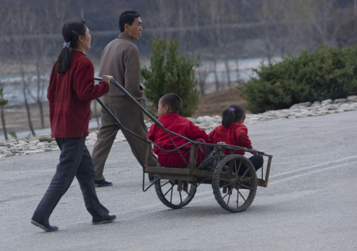 North Korean couple pushing a cart where are their children, Hyangsan county, Mount Myohyang, North Korea