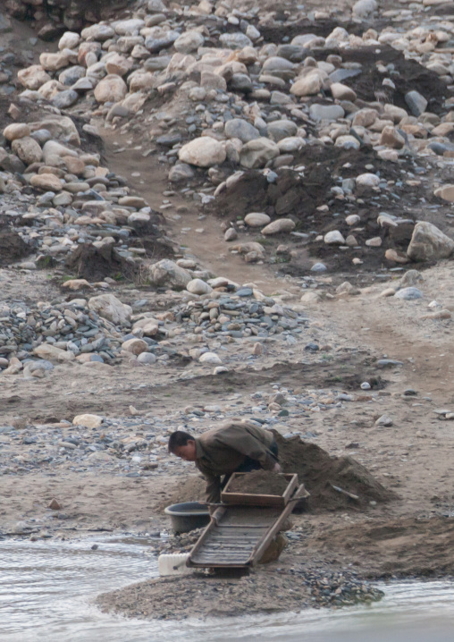 North Korean man panning for gold in a river, Kangwon Province, Wonsan, North Korea