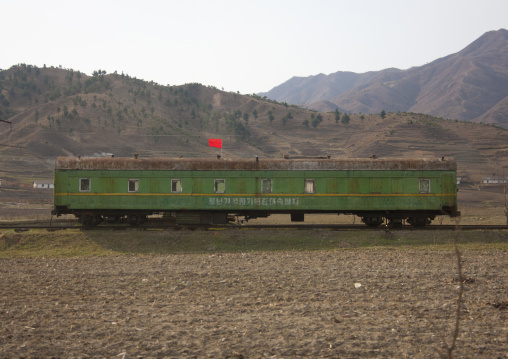 North Korean rusty train with a red flag stopped in the countryside, Kangwon Province, Wonsan, North Korea