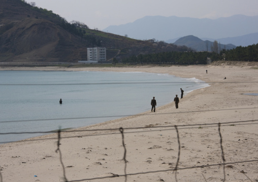 North Korean soldiers walking on a beach in the east sea, Kangwon Province, Wonsan, North Korea