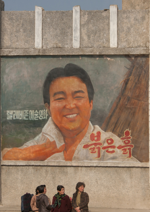 North Korean people below a movie poster, Kangwon Province, Wonsan, North Korea