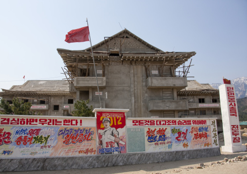 Propaganda billboards in front of a building under construction, Kangwon-do, Mount Kumgang, North Korea