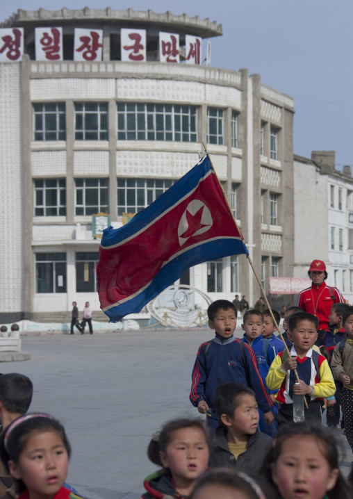 North Korean children parading in the streets on the international workers' day with the national flag, Kangwon Province, Wonsan, North Korea