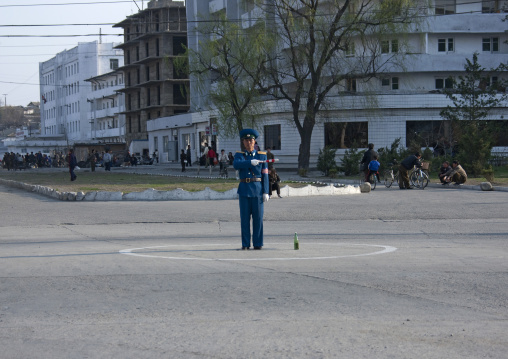 North Korean male traffic security officer in blue uniform in the street, Kangwon Province, Wonsan, North Korea