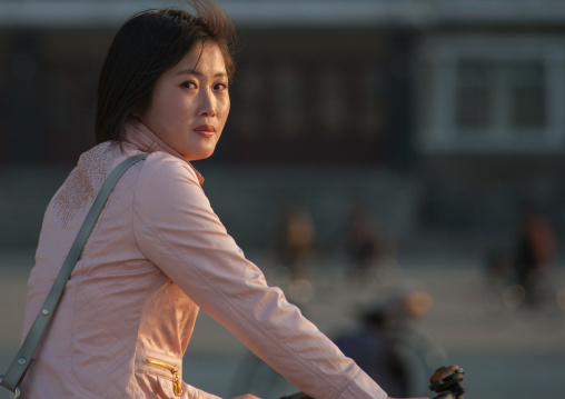 Portrait of a North Korean woman on a bicycle, Kangwon Province, Wonsan, North Korea