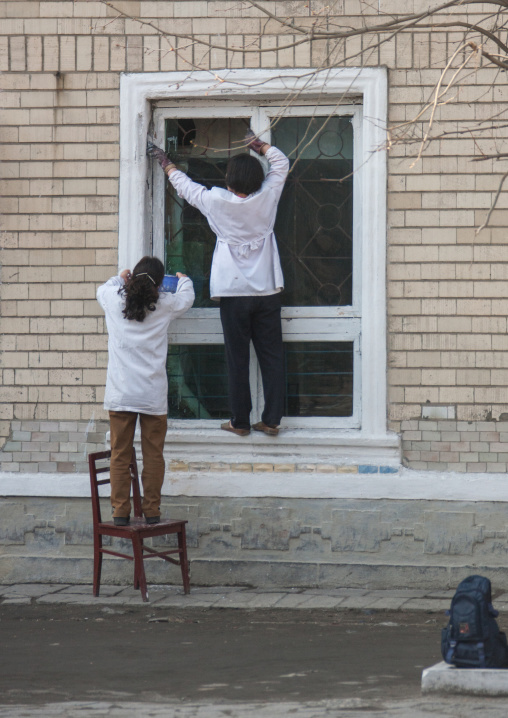 North Korean women fixing a window, Kangwon Province, Wonsan, North Korea