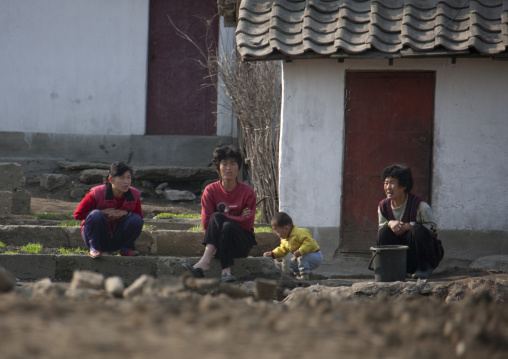 North Korean people sit in front of their house, Pyongan Province, Pyongyang, North Korea