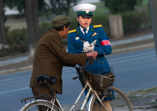 North Korean man with a traffic officier woman in the street, Pyongan Province, Pyongyang, North Korea