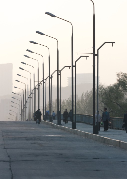 North Korean people walking on the road side in the early morning, Pyongan Province, Pyongyang, North Korea