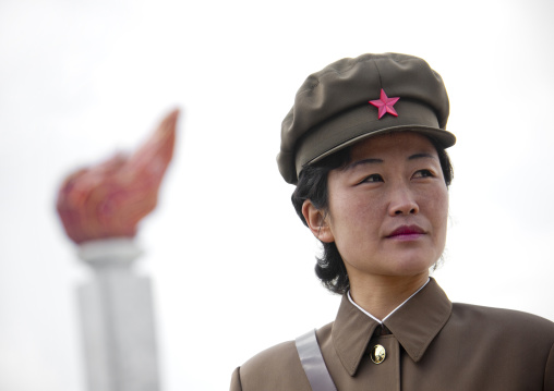 Portrait of a North Korean guide in mount Paektu in front of the Juche flame, Ryanggang Province, Samjiyon, North Korea