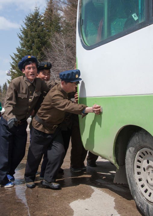 North Korean students pushing a bus out of order, Ryanggang Province, Samjiyon, North Korea