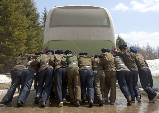 North Korean students pushing a bus out of order, Ryanggang Province, Samjiyon, North Korea