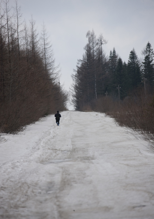 North Korean man walking on an icy road in the countryside, Ryanggang Province, Samjiyon, North Korea