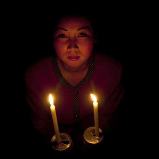 North Korean woman with candles during electricity shortage, North Hamgyong Province, Jung Pyong Ri, North Korea