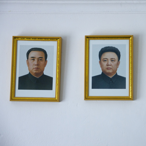Official portraits of Kim il Sung and Kim Jong il in a home, South Pyongan Province, Chongsan-ri Cooperative Farm, North Korea