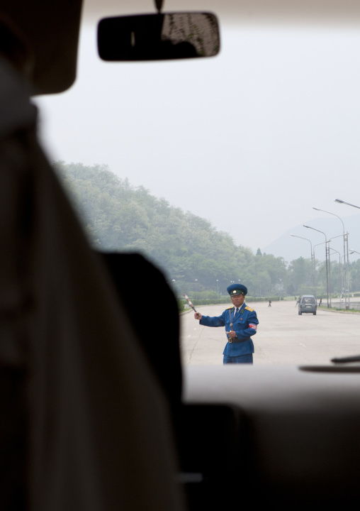 North Korean policeman controlling entrance to the city on the highway, Pyongan Province, Pyongyang, North Korea