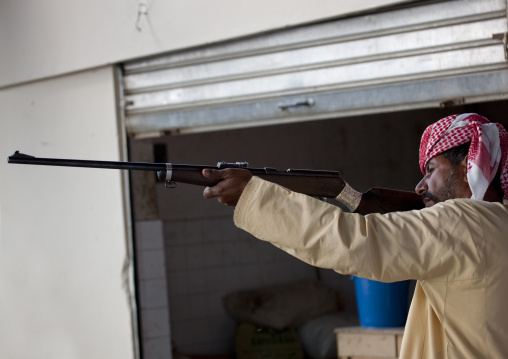 Man Testing A Gun In The Weapons Souk, Sinaw, Oman