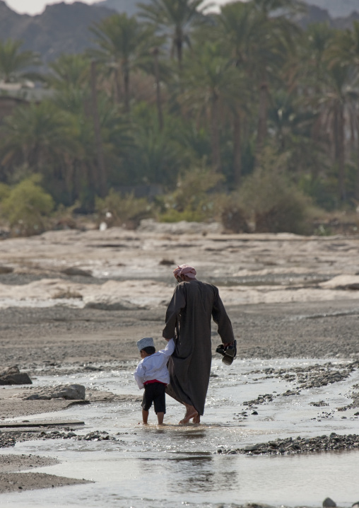 Figure Of Man Walking In The Water With A Kid, Sinaw, Oman